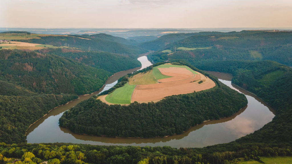 Start of the hike at the viewpoint over the Ourtalschleife where the Our river meanders in the valley.