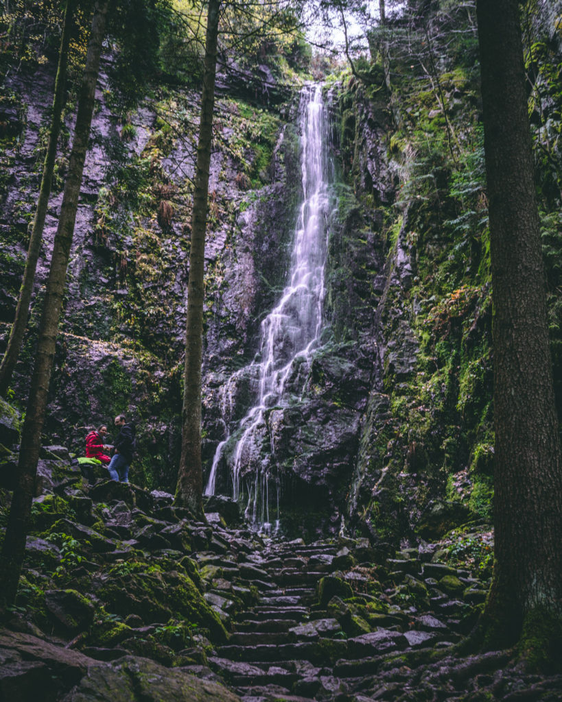 Burgbach waterfall surrounded by green mossy rocks